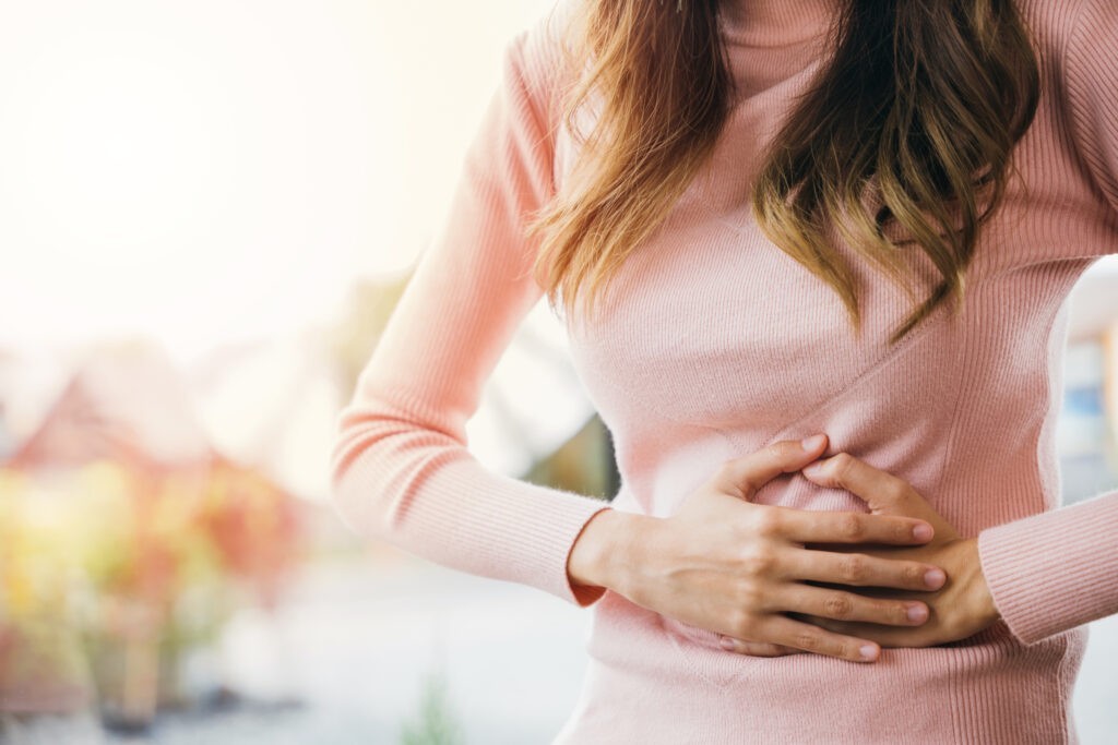 Sick woman unhappy having stomach ache at home disbiosi-intestino